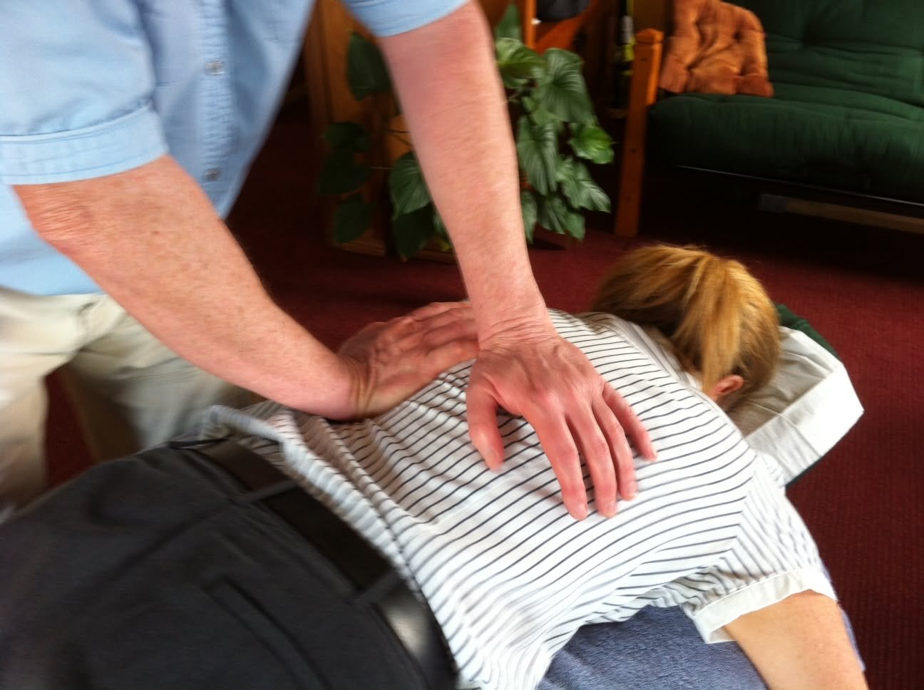 Bruce Sutton treating a patient's back at Progressive Osteopathics